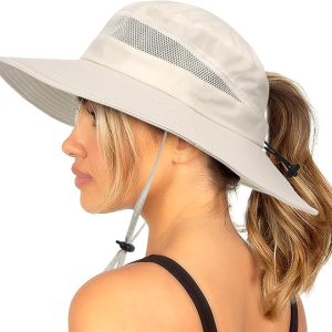 Woman wearing a wide-brim hat with a mesh panel, side profile view, ponytail hairstyle, casual summer style